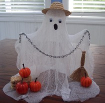 Make a Halloween ghost from cheesecloth and dress him in a straw hat.